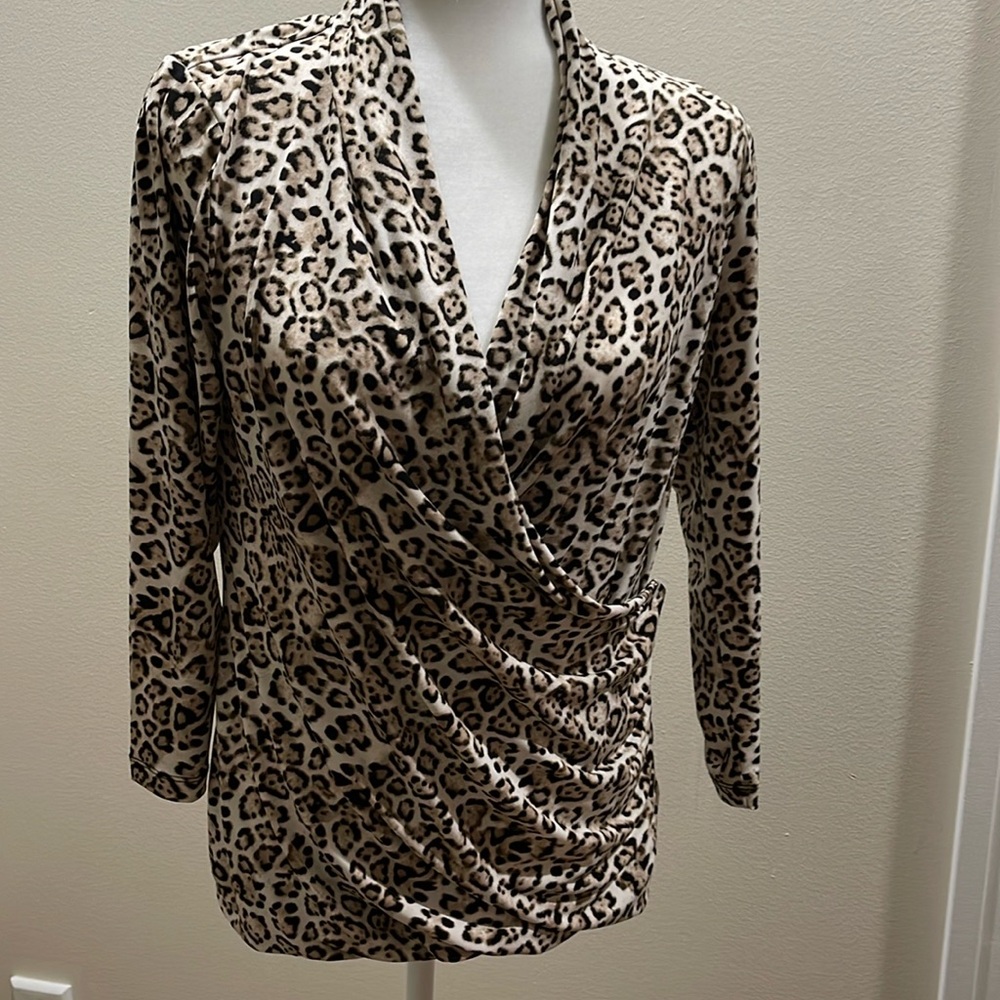 Leopard print top with draped neckline. Knit fabric with some stretch.